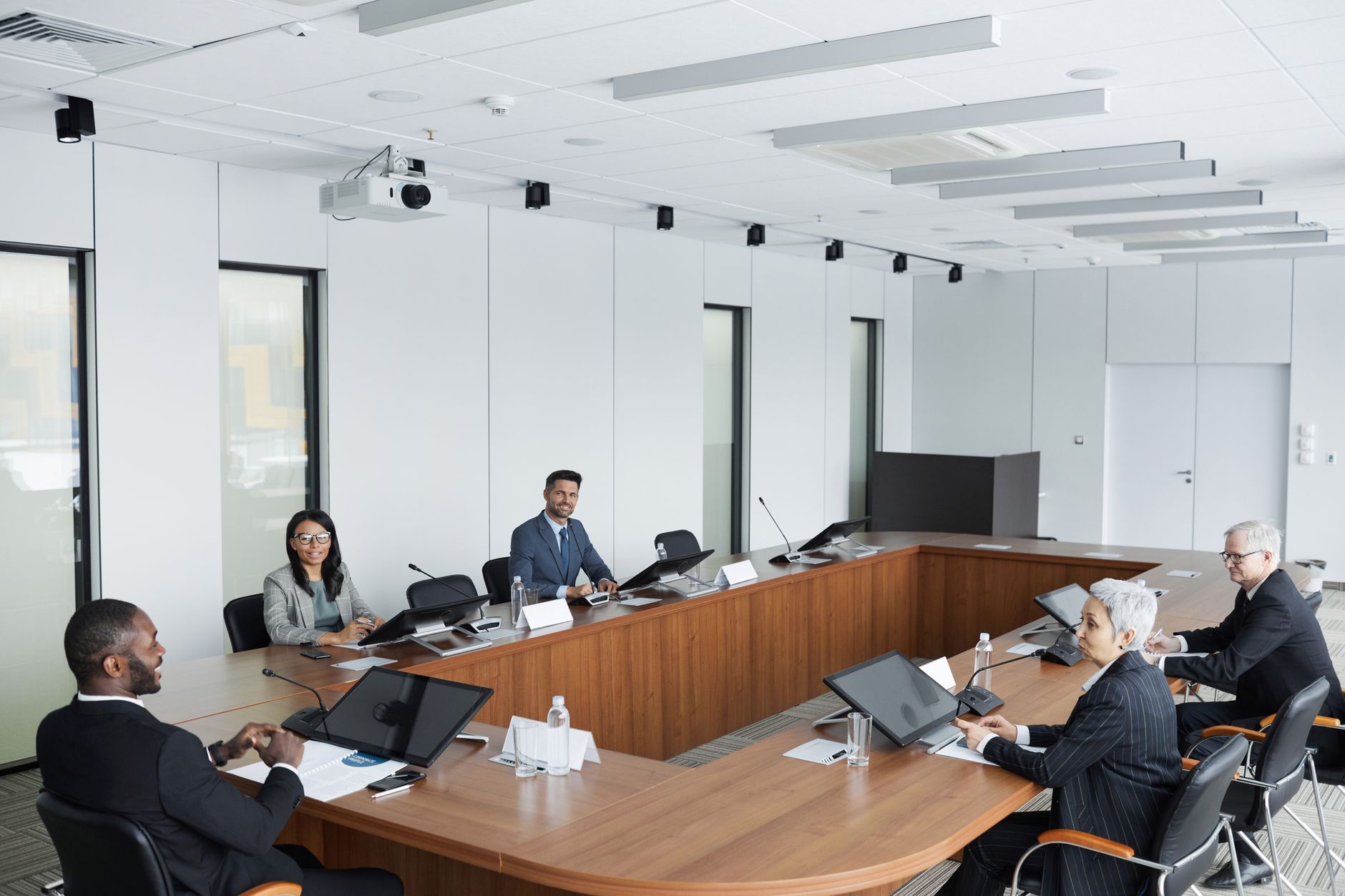 Professional team interacting in boardroom over wellness policies
